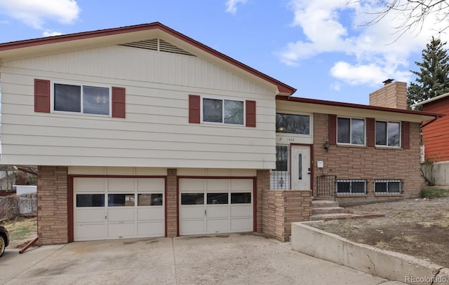 1422 N Chelton Rd, Colorado Springs, CO 80909 - raised ranch with a garage, driveway, and a chimney