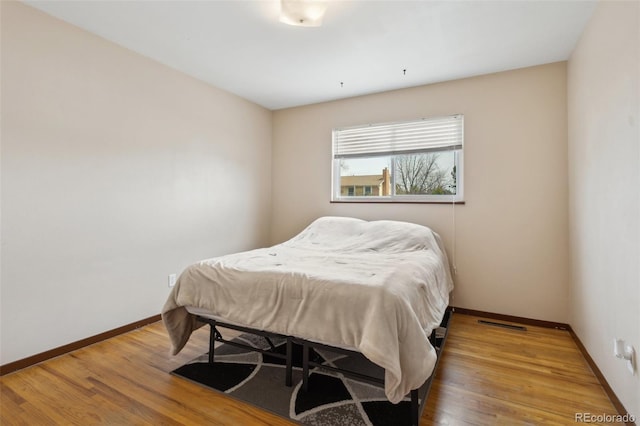 1422 N Chelton Rd, Colorado Springs, CO 80909 - bedroom with baseboards and wood finished floors