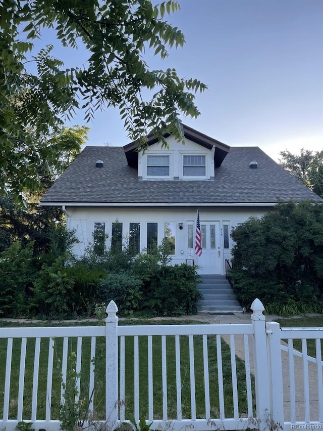 415 N Division Ave, Sterling, CO 80751 - view of front of house with a fenced front yard and a shingled roof