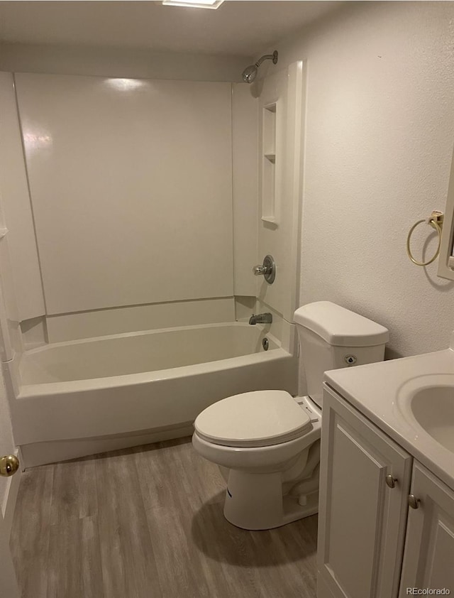 415 N Division Ave, Sterling, CO 80751 - bathroom with wood finished floors, vanity, and bathtub / shower combination