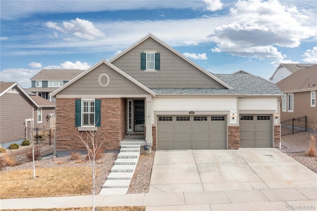 view of front of house featuring an attached garage, a shingled roof, fence, and concrete driveway