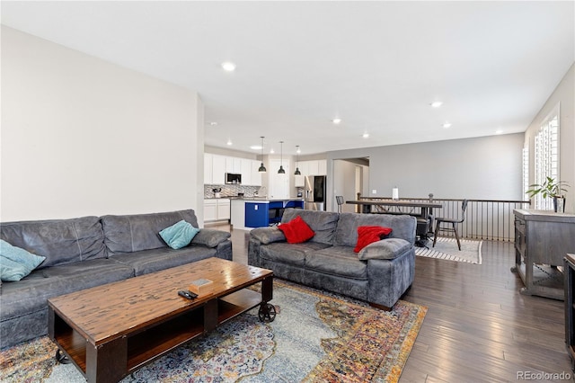 living room featuring recessed lighting and dark wood-style flooring