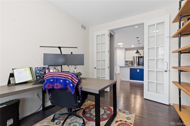 home office with visible vents, dark wood-style flooring, and french doors