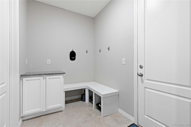 mudroom featuring baseboards and light tile patterned floors