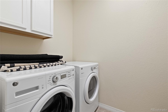 clothes washing area featuring cabinet space, baseboards, and independent washer and dryer