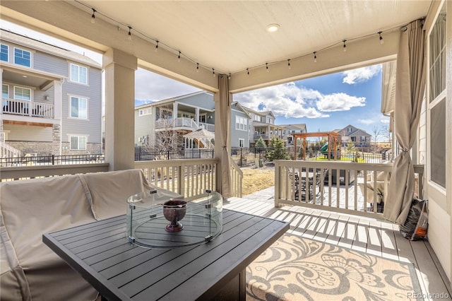 wooden terrace with a residential view and fence