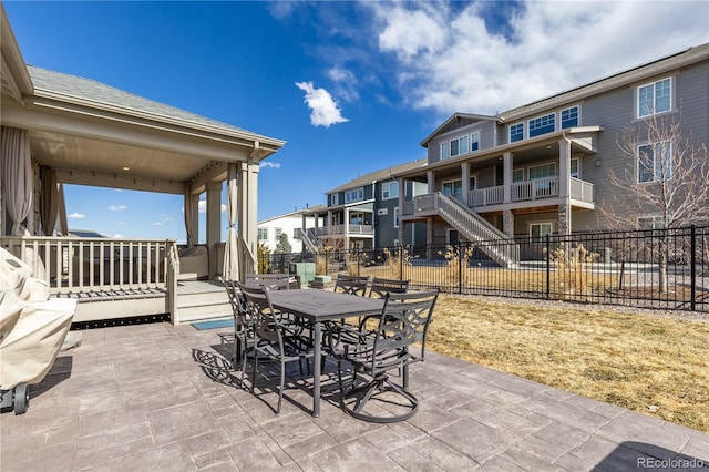 view of patio featuring outdoor dining space and fence