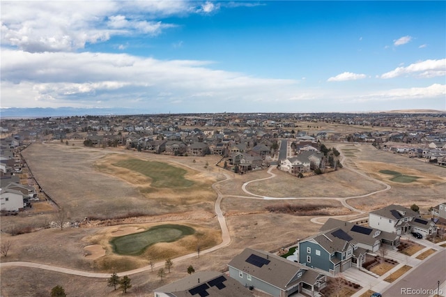 drone / aerial view with view of golf course and a residential view