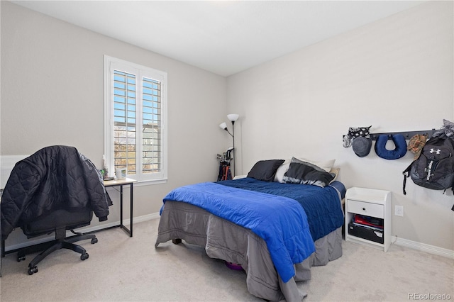 carpeted bedroom featuring baseboards