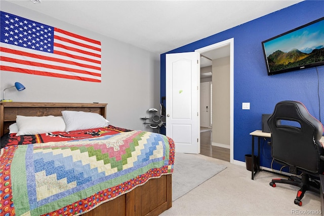 carpeted bedroom featuring baseboards