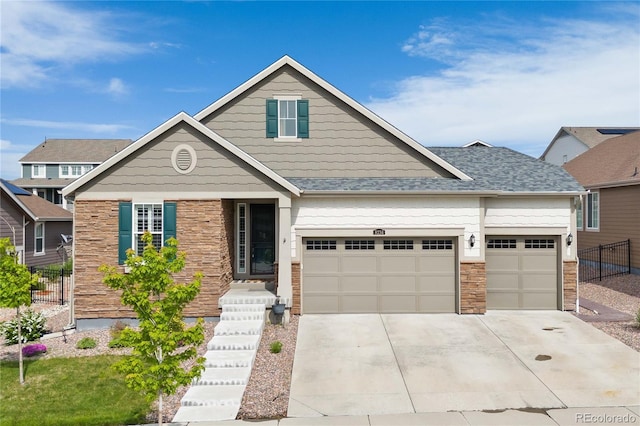 8234 S Vandriver Way, Aurora, CO 80016 - craftsman-style home featuring an attached garage, concrete driveway, and stone siding