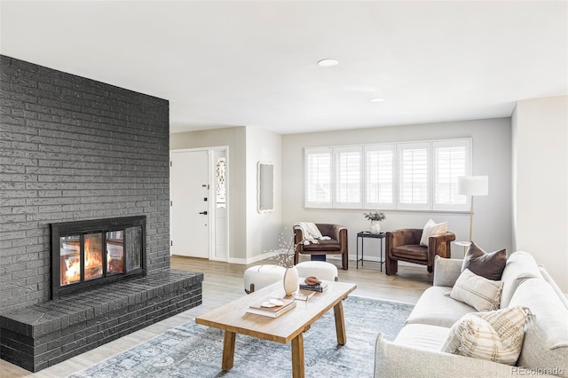 living room featuring a fireplace and light hardwood / wood-style flooring