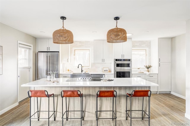 kitchen featuring hanging light fixtures, a center island, and stainless steel appliances