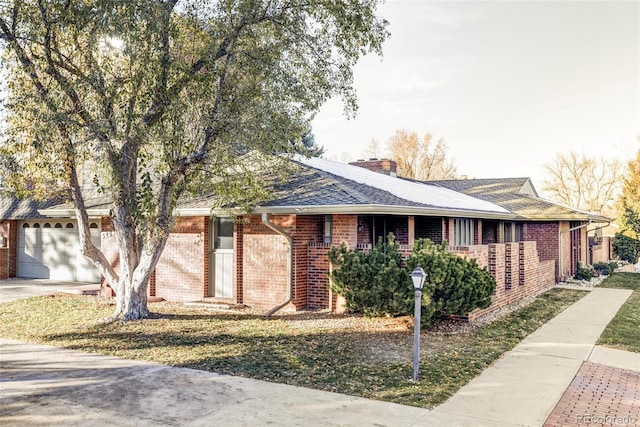 ranch-style home featuring a front yard and a garage