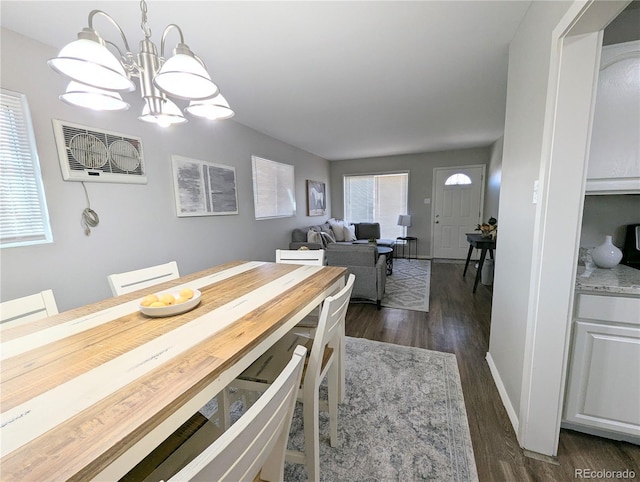 dining space with dark wood-style floors and baseboards