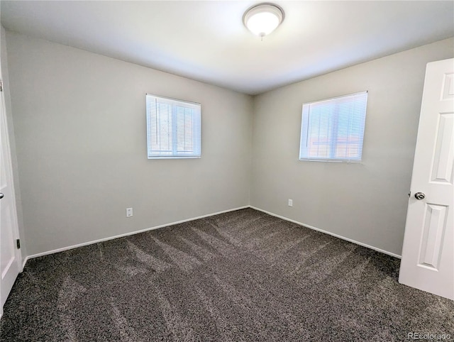 empty room with dark carpet