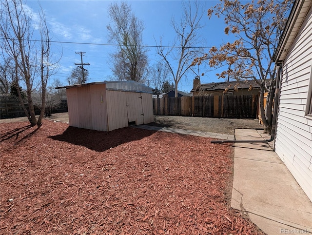 view of yard featuring an outbuilding, fence private yard, and a storage unit