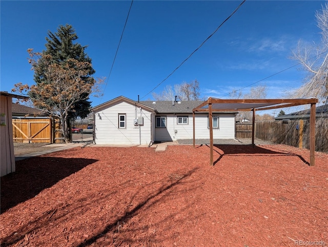 back of house with a gate and fence