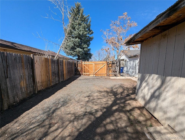 view of yard featuring fence and a gate