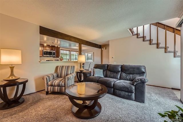 2090 S Hannibal Way Unit F, Aurora, CO 80013 - living area with carpet floors, a textured ceiling, baseboards, and stairway