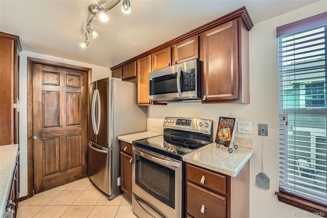 2090 S Hannibal Way Unit F, Aurora, CO 80013 - kitchen with light tile patterned floors and appliances with stainless steel finishes