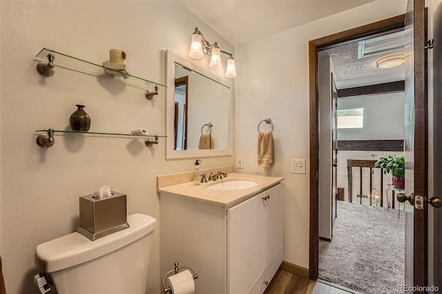 2090 S Hannibal Way Unit F, Aurora, CO 80013 - half bath featuring toilet, wood finished floors, and vanity