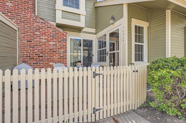 2090 S Hannibal Way Unit F, Aurora, CO 80013 - view of exterior entry featuring brick siding and fence