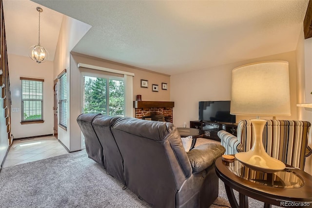 2090 S Hannibal Way Unit F, Aurora, CO 80013 - living room with an inviting chandelier, light carpet, a fireplace, a textured ceiling, and light tile patterned floors