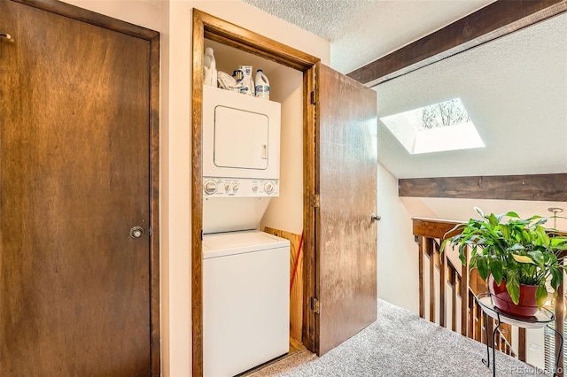 2090 S Hannibal Way Unit F, Aurora, CO 80013 - laundry area with laundry area, a textured ceiling, carpet, stacked washer / dryer, and a skylight