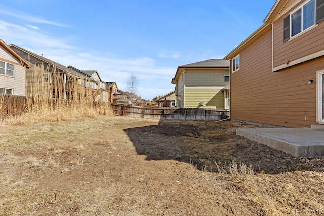 view of yard with a residential view and fence