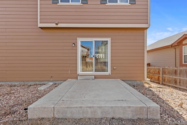 entrance to property featuring fence