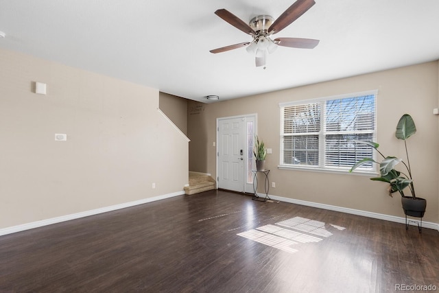 foyer featuring a ceiling fan, baseboards, and wood finished floors