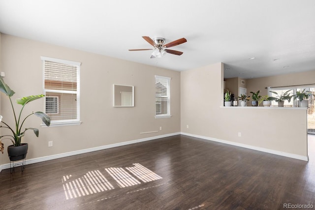 unfurnished living room featuring a healthy amount of sunlight, ceiling fan, baseboards, and wood finished floors