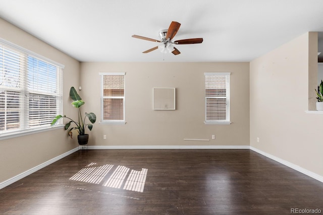 empty room featuring ceiling fan, baseboards, and wood finished floors