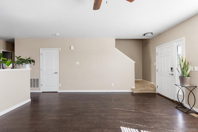 entryway with baseboards, visible vents, ceiling fan, stairway, and wood finished floors