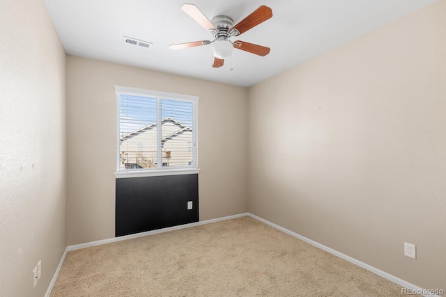 spare room featuring a ceiling fan, carpet, visible vents, and baseboards