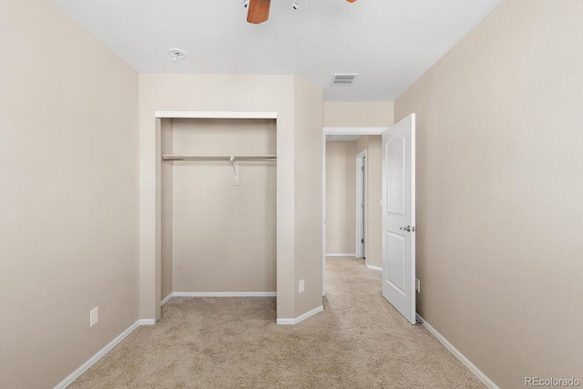 unfurnished bedroom with baseboards, visible vents, ceiling fan, carpet flooring, and a closet