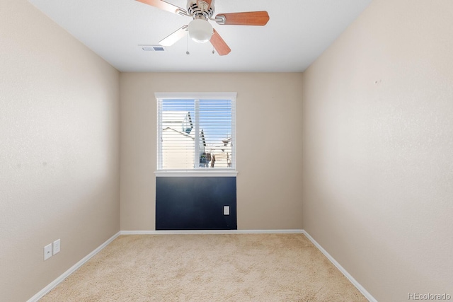 unfurnished room with a ceiling fan, carpet, visible vents, and baseboards