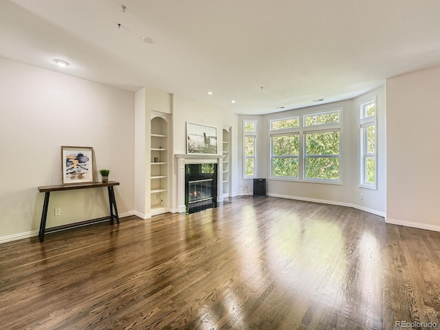 30 Garfield St Unit B, Denver, CO 80206 - unfurnished living room featuring wood finished floors, a fireplace, baseboards, and built in features