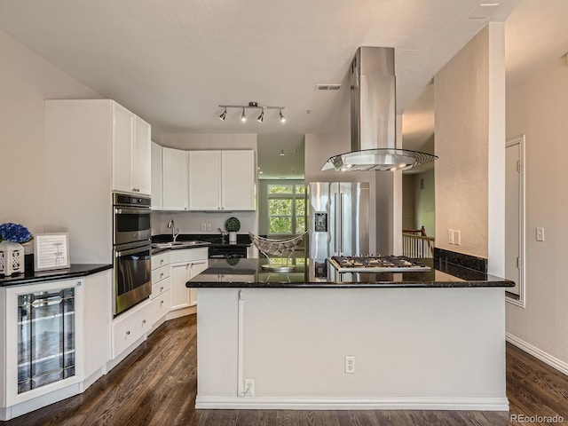 30 Garfield St Unit B, Denver, CO 80206 - kitchen featuring appliances with stainless steel finishes, wine cooler, island exhaust hood, white cabinetry, and dark wood-style flooring