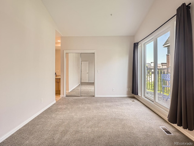 30 Garfield St Unit B, Denver, CO 80206 - unfurnished room with vaulted ceiling, carpet floors, plenty of natural light, and baseboards