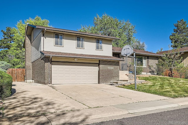 tri-level home with a garage, brick siding, and driveway