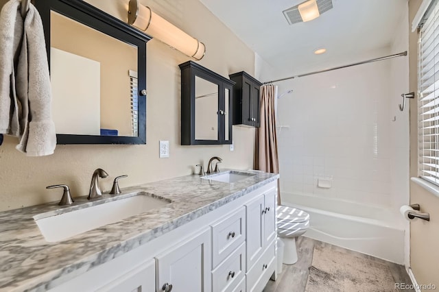 bathroom featuring toilet, shower / bath combo, and double vanity