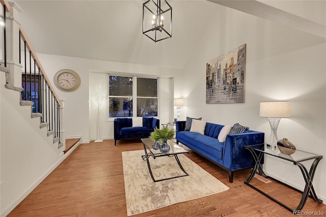 living room featuring wood-type flooring and a notable chandelier