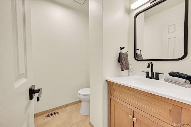 bathroom featuring tile patterned floors, vanity, and toilet