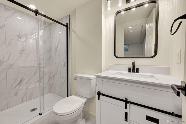 bathroom featuring vanity, toilet, and a shower with shower door