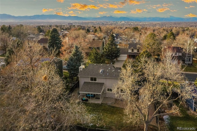 aerial view at dusk featuring a mountain view