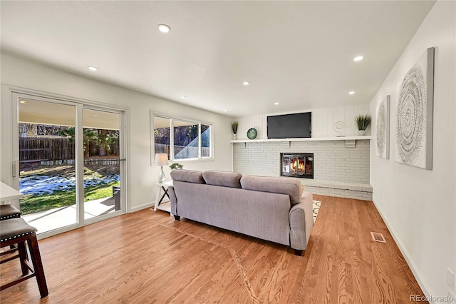 living room featuring a fireplace and light hardwood / wood-style floors