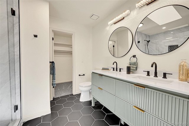 bathroom with tile patterned flooring, toilet, a shower, and vanity