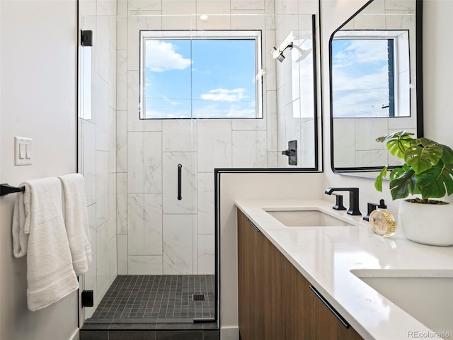 bathroom featuring vanity and an enclosed shower